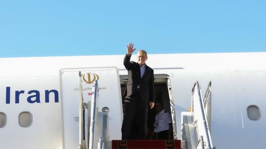 Iranian President Masoud Pezeshkian waves before departing for New York, at Mehrabad Airport in Tehran