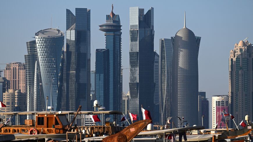 Traditional Qatari dhows docked in front of Doha's skyline from the Corniche promenade, Nov. 28, 2022.