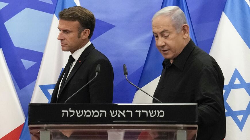 Israeli Prime Minister Benjamin Netanyahu and French President Emmanuel Macron arrive to hold a joint press conference in Jerusalem, Oct. 24, 2023.