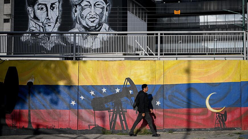 A man walks past a mural depicting oil pumps and the Venezuelan flag, with portraits of Venezuelan independence leader Simon Bolivar (L) and former late President Hugo Chavez (R), in Caracas, Venezuela, on Sept. 3, 2026.