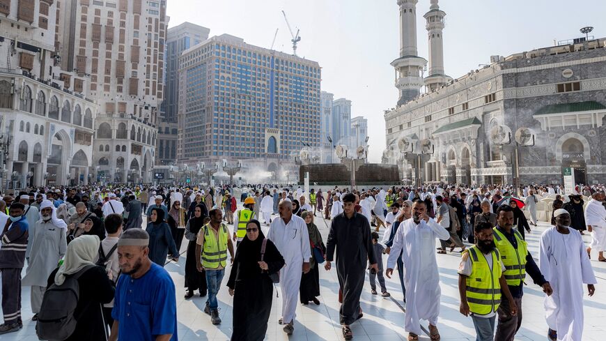 People and pilgrims walk at the Grand Mosque Complex in Saudi Arabia's holy city of Mecca on Sept. 16, 2026.