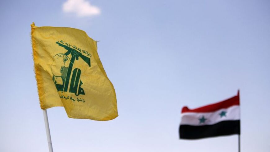 FILE PHOTO: Hezbollah and Syrian flags are seen fluttering in Fleita