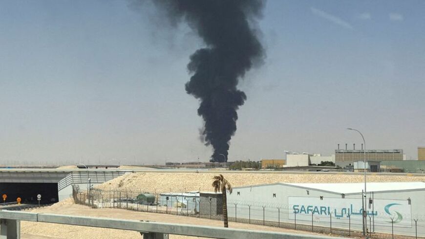 FILE PHOTO: Large plume of black smoke rises from the fuel storage area at King Khalid International Airport, in Riyadh