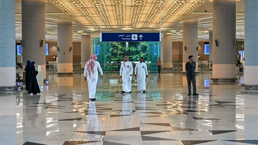 Men walk at a terminal at Saudi Arabia's King Abdulaziz International Airport in Jeddah on December 12, 2019. (Photo by GIUSEPPE CACACE / AFP) (Photo by GIUSEPPE CACACE/AFP via Getty Images)