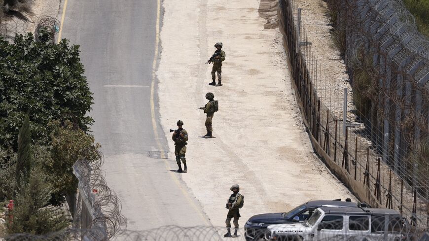 Israeli troops stand guard on the dividing line between the Israeli-annexed Golan Heights and Syrian, near Majdal Shams, July 16, 2025.