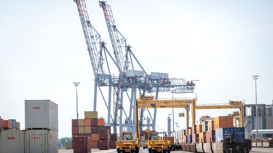 Dock workers load and unload shipping containers in the Port of Montreal in Montreal, Quebec, Canada