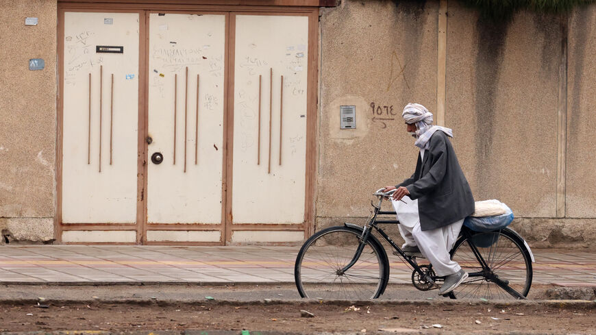 A Baluch Iranian man rides a bicycle in Zahedan, in the southeastern province of Sistan-Baluchistan bordering Afghanistan on Dec. 18, 2025, during a media tour organized by the Iranian government. 