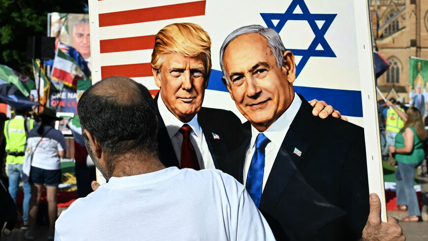 A member of the Iranian community in Australia holds a placard in support of US President Donald Trump and Israeli Prime Minister Benjamin Netanyahu during a rally following US and Israeli attacks on Iran, in Sydney on March 14, 2026. 