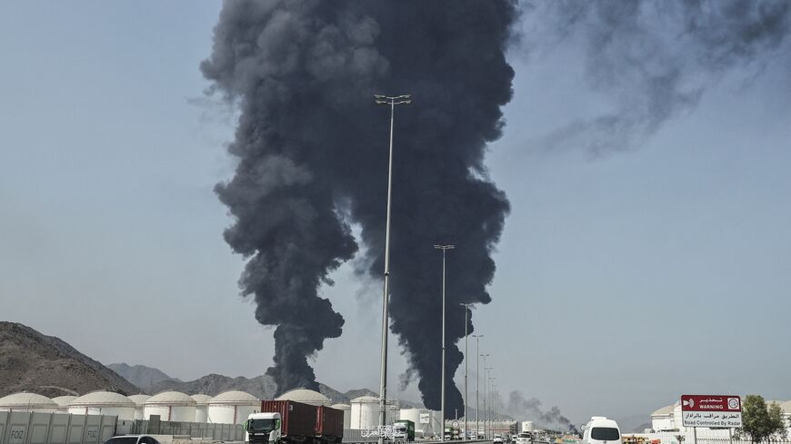 TOPSHOT - Smoke rises from the direction of an energy installation in the Gulf emirate of Fujairah on March 14, 2026. Smoke could be seen rising from the direction of a major UAE energy installation on March 14, in what appeared to be the latest strike targeting the Gulf's petroleum facilities hours after the US struck Iran's Kharg Island. (Photo by AFP via Getty Images) /