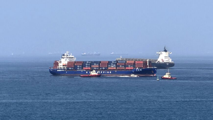 A cargo ship is pictured off coast of the Khor Fakkan Container Terminal, along the Gulf of Oman, on June 28, 2026, after Iran's top diplomat warned that any attempt by shipping to bypass its preferred route through the Strait of Hormuz would "increase tensions" in the Middle East.