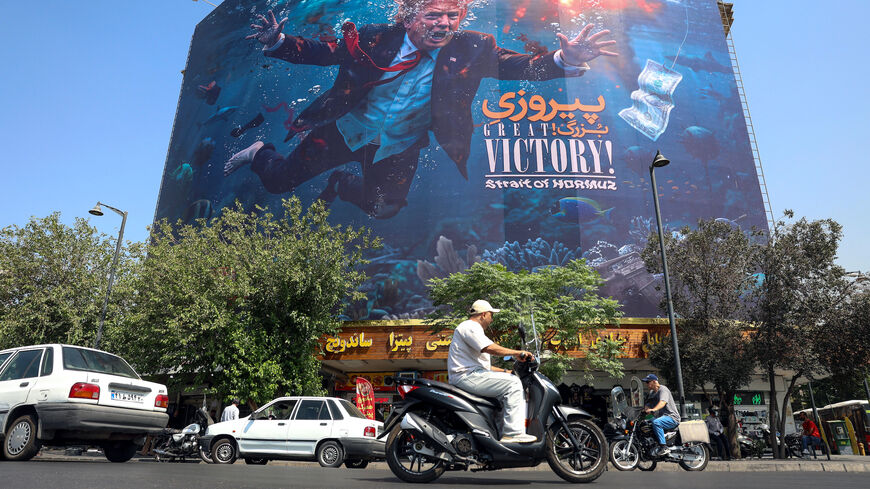 Motorists drive past an anti-US billboard in Tehran on Aug. 24, 2026.