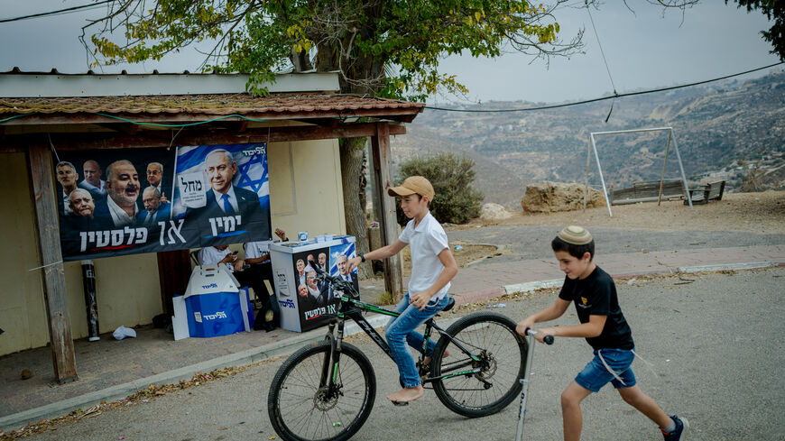 ADORA, WEST BANK - OCTOBER 27: Israeli children ride a bicycle and a scooter past an election campaign stand of Prime Minister Benjamin Netanyahu's Likud party on October 27, 2026 in the Israeli settlement of Adora, West Bank. Voting is underway to choose 120 members of the Knesset, which will determine the make-up of the government that succeeds incumbent Israeli Prime Minister Benjamin Netanyahu's right-wing coalition. Around 500,000 Israeli settlers living in the occupied West Bank and are entitled to ca