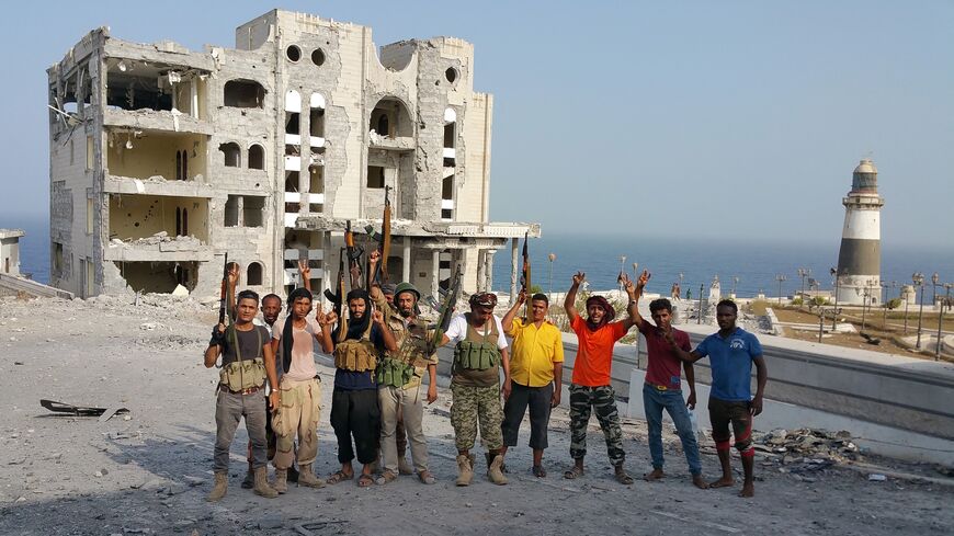 Fighters loyal to Yemen's exiled President Abedrabbo Mansour Hadi pose for a picture near the presidential palace (unseen R) following clashes in Aden's Maashiq neighborhood on July 22, 2015. 