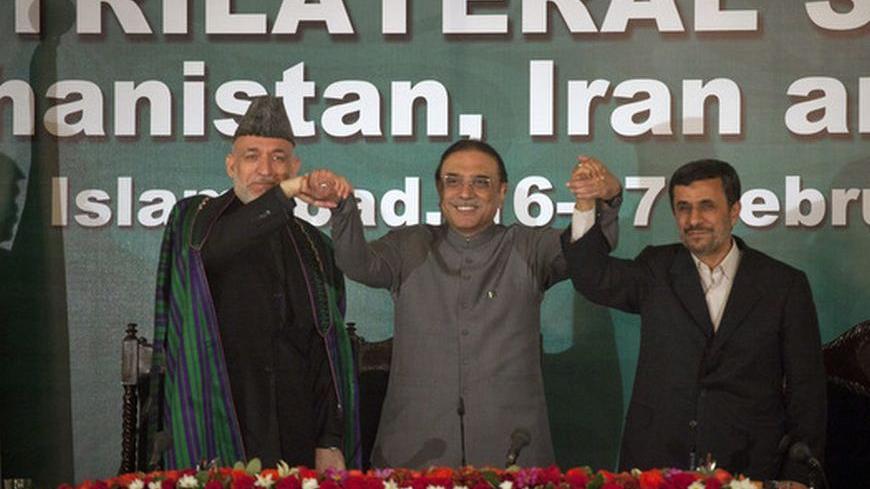 Afghanistan's President Hamid Karzai (L), Pakistan's President Asif Ali Zardari (C) and Iran's President Mahmoud Ahmadinejad join hands after a news conference in Islamabad February 17, 2012. Ahmadinejad, accused by the West of pursuing a nuclear weapons programme, said in Pakistan on Friday foreign nations were determined to dominate the region and this should not be allowed. REUTERS/Mian Khursheed (PAKISTAN - Tags: POLITICS)