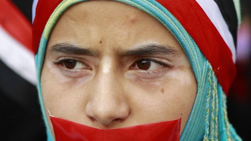 A girl with a taped mouth takes part in a demonstration to demand the ouster of Yemen's President Ali Abdullah Saleh in the southern city of Taiz April 14, 2011. Yemen's opposition rejected on Thursday an offer to join Gulf-mediated talks in Saudi Arabia on a transfer of power in the Arabian Peninsula state and set a two-week deadline for Saleh to step down. REUTERS/Khaled Abdullah (YEMEN - Tags: POLITICS CIVIL UNREST)