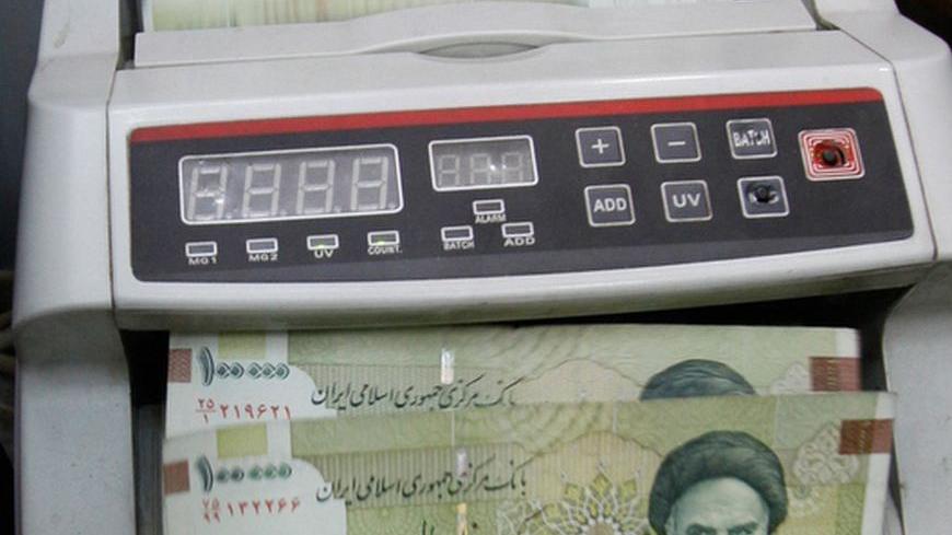 A money dealer counts Iranian rial banknotes in his office in Baghdad January 30, 2012. In the money changing shops dotted around Baghdad's Karrada district, Iraqi merchants dabble in many currencies, but these days some joke that banknotes from neighbouring Iran and Syria are only worth plastering on windows as decorations. Picture taken January 30, 2012. To match Feature IRAQ-SANCTIONS/     REUTERS/Saad Shalash (IRAQ - Tags: SOCIETY BUSINESS)