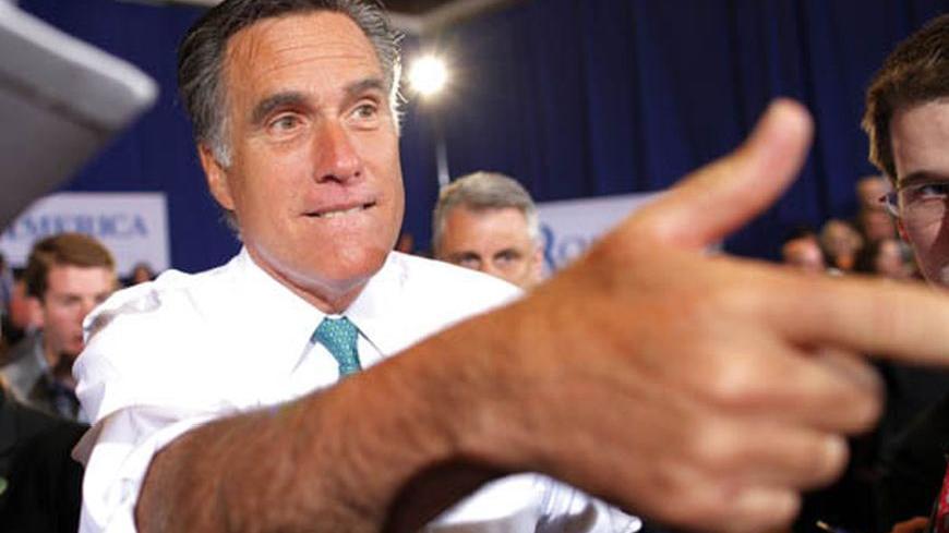 U.S. Republican presidential candidate and former Massachusetts Governor Mitt Romney greets audience members during a campaign stop in Warwick, Rhode Island April 11, 2012. REUTERS/Brian Snyder    (UNITED STATES - Tags: POLITICS ELECTIONS)