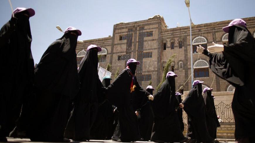 A protest leader gives directions to fellow protesters as they march during a demonstration to demand that relatives of Yemen's former president Ali Abdullah Saleh be dismissed from senior army and police posts, in Sanaa May 10, 2012. REUTERS/Khaled Abdullah (YEMEN - Tags: POLITICS CIVIL UNREST)