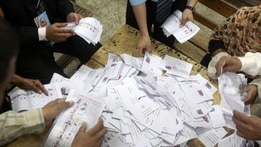 Electoral coordinators count votes at a school used as a polling station in Cairo, May 24, 2012. Egyptians queued patiently to vote on Thursday, eager to pick their leader for the first time in a national history dating to the pharaohs, with Islamists and secular-minded rivals who served under deposed President Hosni Mubarak heading the field.   REUTERS/Asmaa Waguih (EGYPT - Tags: POLITICS ELECTIONS)