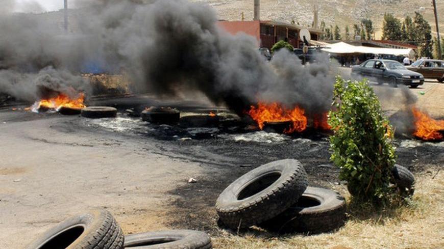 Tyres set ablaze by residents to protest against the kidnap of a hardline Sunni Lebanese supporter of the Syrian revolt against President Bashar al-Assad by Lebanese Alawites, block the main entrance of the northern Lebanese village of Wadi Khaled June 11, 2012, At least seven Lebanese and Syrian citizens have been kidnapped in northern Lebanon near the border with Syria, the first such reported abductions fuelled by tensions over the uprising in Syria that have spilled into its small neighbour.  REUTERS/Ro