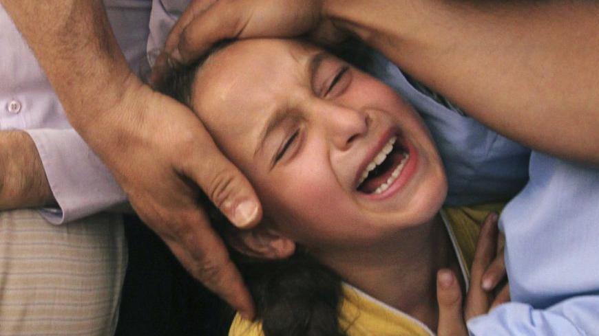 The daughter of Thair Al-Baik, a Palestinian militant from the Al-Qassam brigades, the armed wing of the Hamas movement, mourns during her father's funeral in Jabalya, in the northern Gaza Strip June 21, 2012. The bodies of two militants, including Al-Baik, were recovered on Thursday in a tunnel at a Hamas training camp which was hit by an Israeli air strike on Tuesday, Hamas sources said. REUTERS/Mohammed Salem (GAZA - Tags: POLITICS CIVIL UNREST)