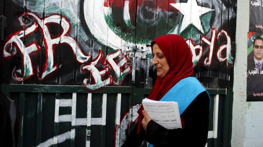 Hannan Bachir, candidate for the Justice and Construction Party, the political arm of the Libyan Muslim Brotherhood, walks during her election campaign in a suburb of Tripoli July 4, 2012. Libyans head to the polls on July 7 to elect a national assembly in the nation's first election in a generation almost a year after ousting Muammar Gaddafi in a NATO-backed rebellion.  REUTERS/Zohra Bensemra (LIBYA - Tags: ELECTIONS POLITICS)