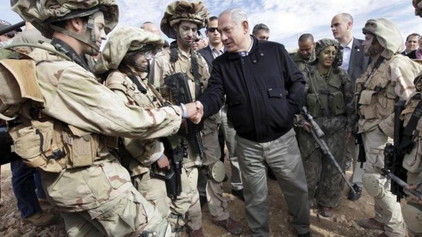 Israel's Prime Minister Benjamin Netanyahu (C) meets with soldiers from the Israeli Defence Force (IDF) during a tour of the Israel and Egypt border in southern Israel January 21, 2010.
REUTERS/Ariel Jerozolimsk/Pool (ISRAEL - Tags: MILITARY POLITICS)