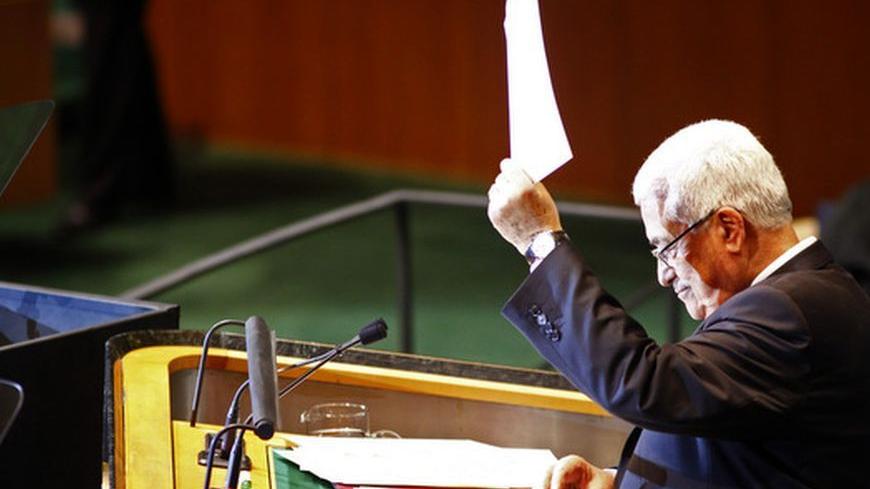 Palestinian Authority president Mahmoud Abbas holds up a letter to United Nations Secretary General Ban Ki-Moon requesting Palestinian statehood at the 66th United Nations General Assembly at U.N. headquarters in New York September 23, 2011. REUTERS/Eric Thayer (UNITED STATES - Tags: POLITICS)