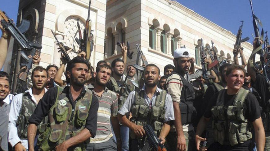 Members of the Free Syrian Army are seen in Azzaz, Aleppo province July 19, 2012. REUTERS/Shaam News Network/Handout  (SYRIA - Tags: POLITICS CIVIL UNREST) FOR EDITORIAL USE ONLY. NOT FOR SALE FOR MARKETING OR ADVERTISING CAMPAIGNS. THIS IMAGE HAS BEEN SUPPLIED BY A THIRD PARTY. IT IS DISTRIBUTED, EXACTLY AS RECEIVED BY REUTERS, AS A SERVICE TO CLIENTS