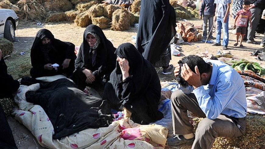 Relatives mourn over the bodies which were recovered in the earthquake-stricken village of Varzaqan near Ahar, in the East Azerbaijan province, August 12, 2012. Iran's government faced criticism from lawmakers and the public on Monday over its handling of relief efforts after two large earthquakes killed 300 people and injured thousands in the northwest of the country. Picture taken August 12, 2012. REUTERS/Arash Khamooshi/ISNA (IRAN - Tags: DISASTER ENVIRONMENT POLITICS) FOR EDITORIAL USE ONLY. NOT FOR SAL