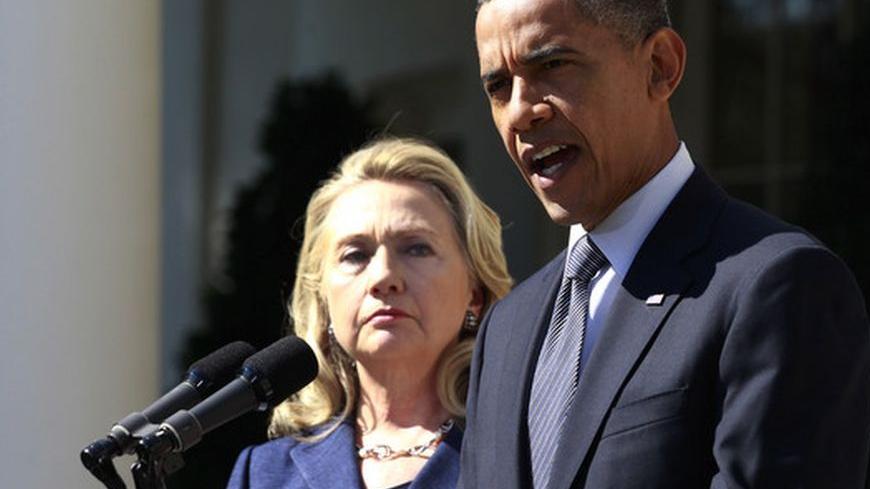 U.S. President Barack Obama delivers a statement alongside Secretary of State Hillary Clinton, following the death of the U.S. Ambassador to Libya, Chris Stevens, and others, from the Rose Garden of the White House in Washington, September 12, 2012. REUTERS/Jason Reed (UNITED STATES - Tags: POLITICS DISASTER)