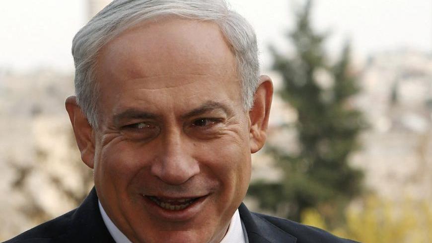 Israeli Prime Minister Benjamin Netanyahu (C) speaks during his meeting with ambassadors to Israel from Asia, in Jerusalem December 19, 2012. Netanyahu said on Wednesday his government would press ahead with expanding Jewish settlements around Jerusalem despite Western criticism of its plan to build 6,000 more homes in territory Palestinians seek for a state. REUTERS/Ronen Zvulun (JERUSALEM - Tags: POLITICS)