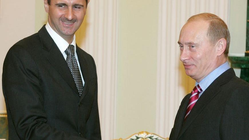 Russia's President Vladimir Putin (R) and Syrian President Bashar al-Assad  shake hands as they meet in Moscow's Kremlin December 19, 2006.   REUTERS/Sergei Karpukhin (RUSSIA)