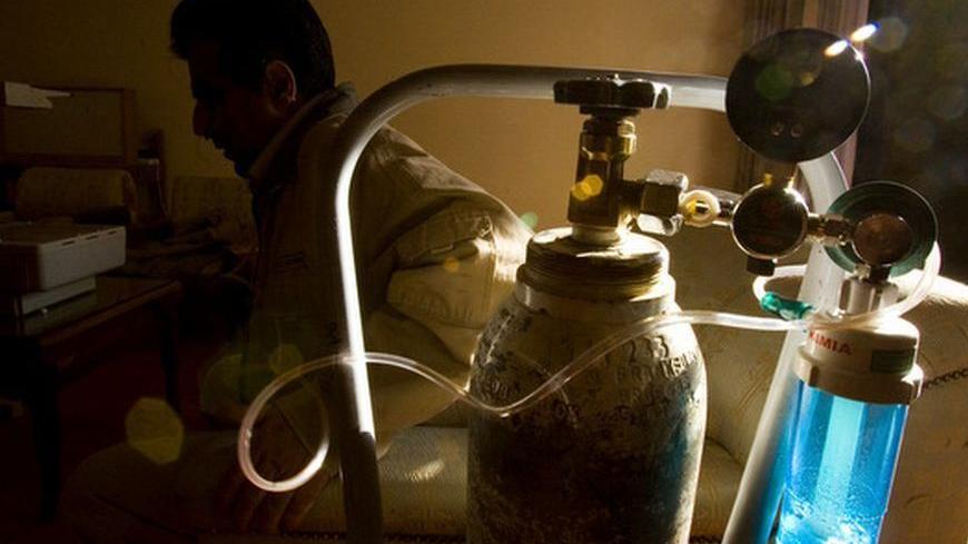 An Iranian man, who was injured in an Iraqi chemical attack during the 1980-1988 Iran-Iraq war, uses oxygen as he waits for a doctor at a government-sponsored medical gathering of visiting doctors in the city of Isfahan, 450 km (281 miles) south of Tehran, October 20, 2007. The doctors are in Isfahan to check on the health of the victims. REUTERS/Morteza Nikoubazl (IRAN)