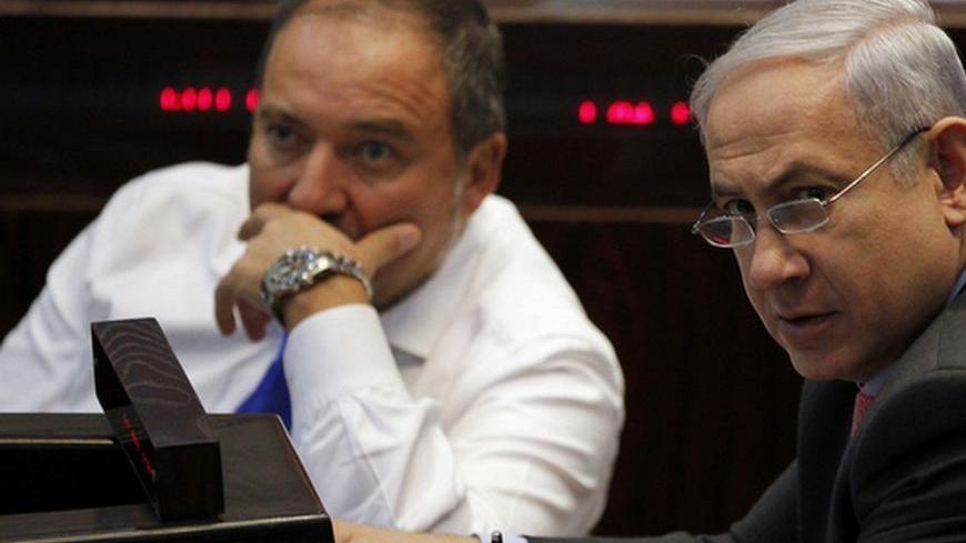 Israel's Prime Minister Benjamin Netanyahu (R) and Foreign Minister Avigdor Lieberman attend a session of the Knesset, the Israeli parliament, in Jerusalem August 3, 2011. Israel's parliament passed a law on Wednesday aimed at cutting housing prices, but protesters seeking wider economic reforms pledged to step up their campaign against rising living costs. Netanyahu has been under pressure in the past few weeks to lower living costs in what local media have dubbed an uprising of the middle class. REUTERS/B