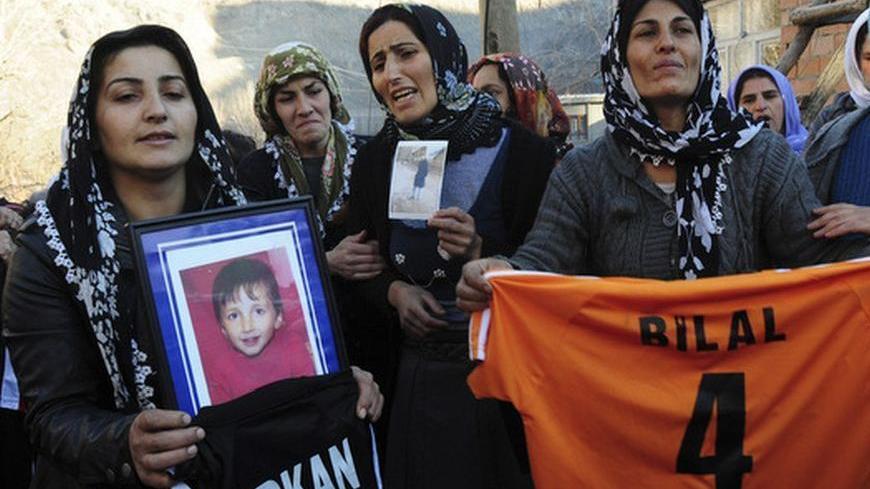Relatives holding pictures and belongings of air strike victims mourn during a funeral ceremony in Gulyazi near the southeastern Turkish town of Uludere, in the Sirnak province, December 30, 2011. Turkish rights groups called on Friday for a U.N.-sponsored investigation after Turkish warplanes killed 35 villagers in an airstrike targeting Kurdish rebels on the Iraqi border that the government has called an operational mistake. REUTERS/Stringer (TURKEY - Tags: CIVIL UNREST DISASTER)