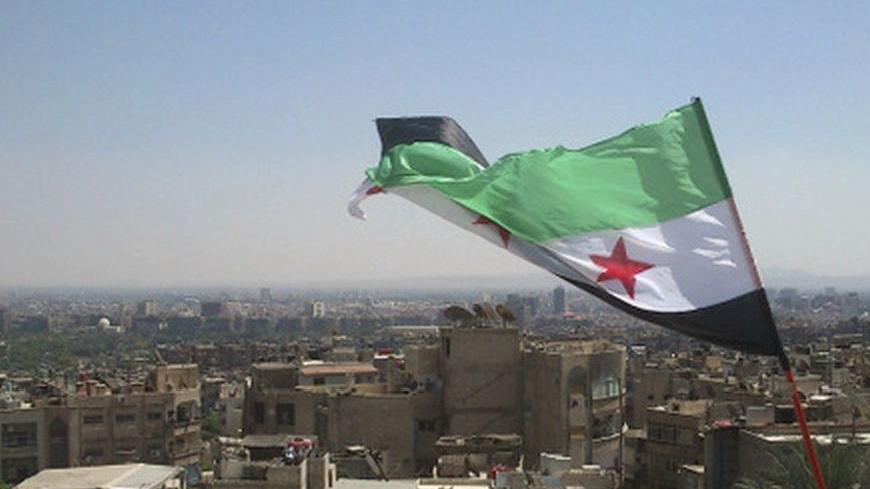 An opposition flag is seen over neighborhood Ruknuddin in Damascus August 5, 2012. Picture taken August 5, 2012. REUTERS/Shaam News Network/Handout (SYRIA - Tags: POLITICS CIVIL UNREST) FOR EDITORIAL USE ONLY. NOT FOR SALE FOR MARKETING OR ADVERTISING CAMPAIGNS. THIS IMAGE HAS BEEN SUPPLIED BY A THIRD PARTY. IT IS DISTRIBUTED, EXACTLY AS RECEIVED BY REUTERS, AS A SERVICE TO CLIENTS