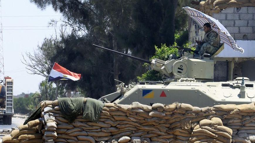 An Egyptian soldier guards a checkpoint at Rafah city, some 350 km (217 miles) northeast of Cairo August 9, 2012. Egyptian police fought gunmen in northern Sinai's main town of al-Arish on Thursday, state television reported, a day after security forces began a crackdown on Islamist militants in the region. REUTERS/Mohamed Abd El Ghany  (EGYPT - Tags: POLITICS CIVIL UNREST MILITARY)