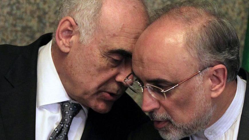 Egyptian Foreign Minister Mohamed Kamel Amr (L) speaks to Iranian Foreign Minister Ali Akbar Salehi during a news conference after a meeting regarding the Syrian crisis, in Cairo September 17, 2012. Saudi Arabia stayed away from a meeting on the Syria crisis convened by regional powers on Monday, setting back a forum grouping Iran - President Bashar al-Assad's main Middle East ally - and his leading opponents in the region. The "contact group" of Egypt, Iran, Turkey and Saudi Arabia arose from an initiative