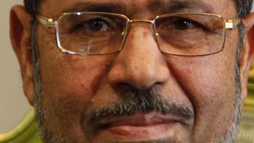 Egypt's President Mohamed Mursi smiles during a meeting with South Korea's presidential envoy and former Foreign Minister Yu Myung-hwan (not in picture) at the presidential palace in Cairo October 8, 2012, a day after Mursi's "Al Nhada (Renaissance) project. The project is primarily a economic and social programme comprising of promises the president vowed to fulfil within 100 days of taking office. Mursi has won grudging respect from detractors in his first 100 days by sending the army back to barracks fas