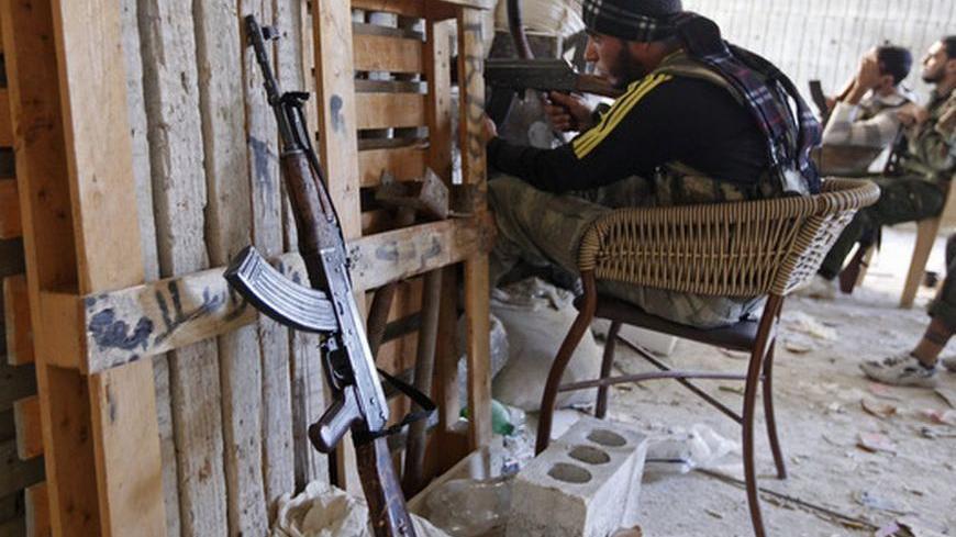 Members of the Free Syrian Army are seen at a front line in Bustan al Basha in Aleppo city, northern Syria October 12, 2012. REUTERS/Zain Karam (SYRIA - Tags: CIVIL UNREST POLITICS CONFLICT TPX IMAGES OF THE DAY)