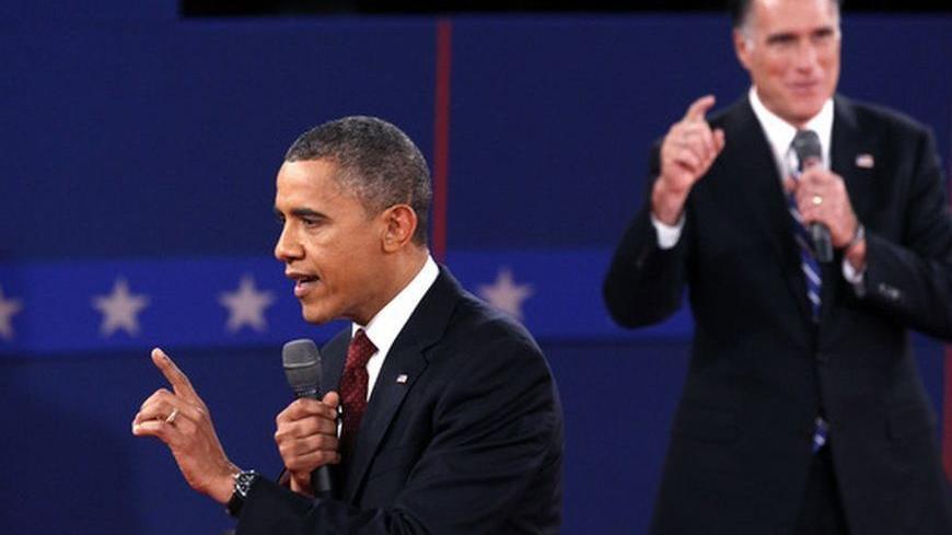 U.S. Republican presidential nominee Mitt Romney (R) and U.S. President Barack Obama speak at the same time during the second U.S. presidential campaign debate in Hempstead, New York, October 16, 2012. REUTERS/Jim Young (UNITED STATES  - Tags: POLITICS ELECTIONS USA PRESIDENTIAL ELECTION)