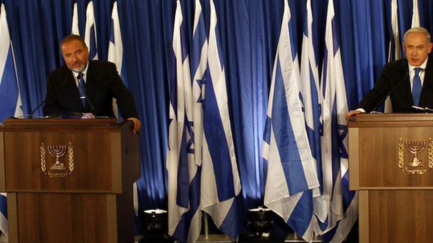Israel's Prime Minister Benjamin Netanyahu (R) and Foreign Minister Avigdor Lieberman hold a joint news conference in Jerusalem October 25, 2012. Netanyahu said on Thursday he was merging his Likud party with that of his ultra-nationalist coalition ally Lieberman in a hard-right tack ahead of Israel's Jan. 22 election.
REUTERS/Ammar Awad (JERUSALEM - Tags: POLITICS)