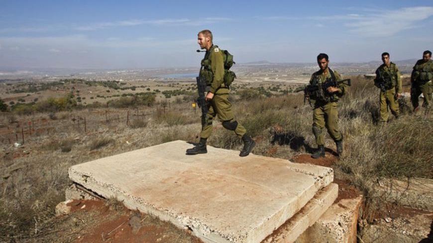 Israeli soldiers walk near Alonei Habashan close to the Israeli-Syrian border in the Golan Heights November 4, 2012. Three Syrian tanks entered the demilitarised zone in the Golan Heights between Israel and Syria on Saturday, an Israeli military spokeswoman said. Israeli media said the tanks were involved in fighting rebels trying to overthrow Syrian President Bashar al-Assad. REUTERS/Nir Elias (POLITICS CIVIL UNREST MILITARY)