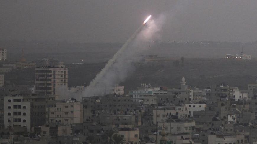 Smoke trails are seen as a rocket is launched from the northern Gaza Strip towards Israel November 17, 2012. Palestinian militants fired a rocket at Tel Aviv on Saturday but it was intercepted in mid-air by a newly deployed Israeli anti-missile battery and caused no casualties or damage, police said. REUTERS/Majdi Fathi (GAZA - Tags: CIVIL UNREST MILITARY POLITICS)