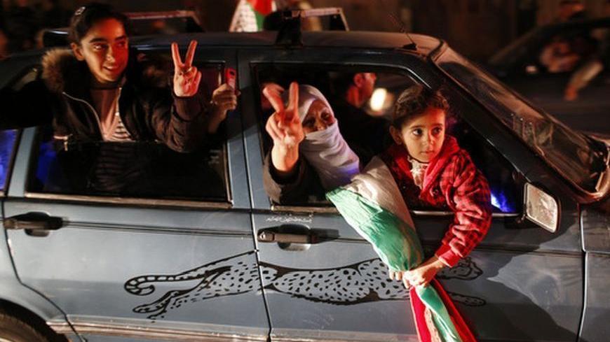 Palestinians celebrate on a street in Gaza City November 30, 2012. The 193-nation U.N. General Assembly overwhelmingly approved a resolution on Thursday to upgrade the Palestinian Authority's observer status at the United Nations from "entity" to "non-member state," implicitly recognizing a Palestinian state. REUTERS/Mohammed Salem (GAZA - Tags: POLITICS)