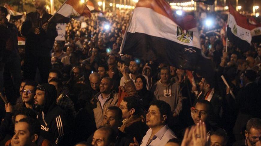 Protesters chant anti-Mursi slogans in front of the presidential palace in Cairo, December 4, 2012. Egypt's opposition called for mass protests on Tuesday against the Islamist-led government's drive to hold a snap referendum on a new constitution after sweeping aside judicial obstacles. REUTERS/Asmaa Waguih (EGYPT - Tags: POLITICS CIVIL UNREST)