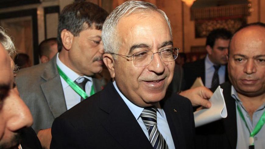 Palestinian Prime Minister Salam Fayyad (C) attends the opening session of an international conference of solidarity with Palestinian and Arab prisoners and detainees in Israel's prisons, in Baghdad December 11, 2012. REUTERS/Thaier Al-Sudani (IRAQ - Tags: POLITICS CIVIL UNREST)