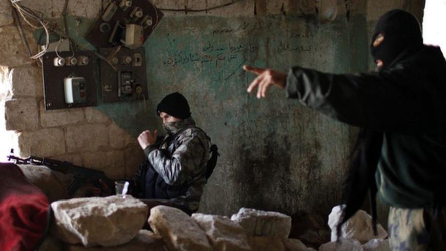 Fighters from Islamist Syrian rebel group Jabhat al-Nusra take their positions on the front line during a clash with Syrian forces loyal to President Bashar al Assad in Aleppo December 24, 2012. Syria special envoy Lakhdar Brahimi discussed solving the country's conflict with President Bashar al-Assad on Monday, but the opposition expressed deepening frustration with the mission following what it called the latest massacre of civilians. REUTERS/Ahmed Jadallah (SYRIA - Tags: CIVIL UNREST POLITICS)