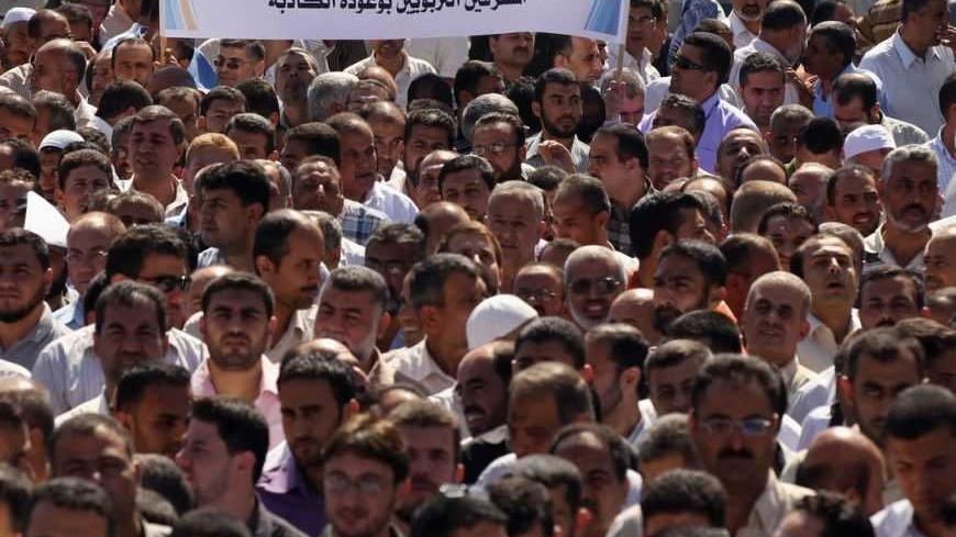 Palestinian teachers take part in a protest at the United Nation Relief and Work Agency (UNRWA) headquarters in Gaza City October 5, 2011. Thousands of Gaza teachers quit their classes on Wednesday to protest at at U.N refugee agency's suspension of a Palestinian staffer, rising tension between UNRWA and Gaza's Islamist Hamas rulers. REUTERS/Mohammed Salem (GAZA - Tags: POLITICS EDUCATION CIVIL UNREST)
